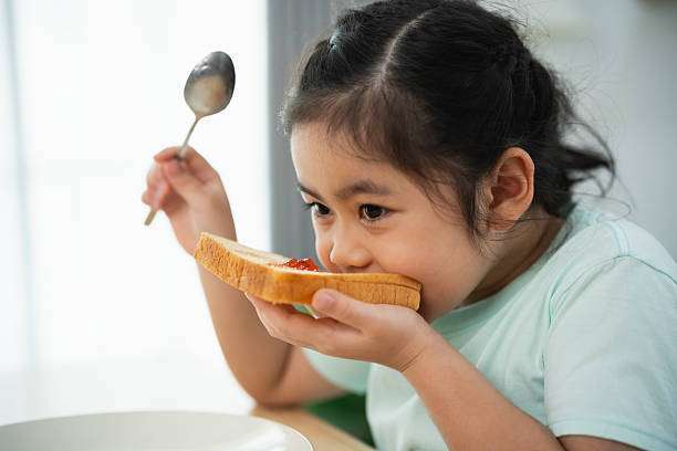 Happy child enjoying delicious toast, toaster