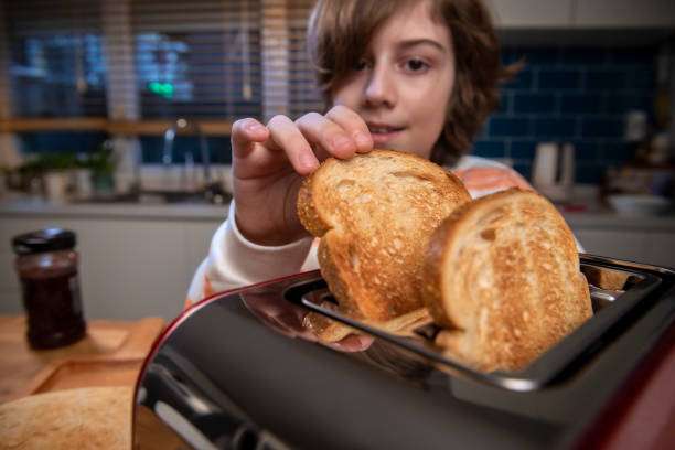 The toast is ready to be put into the toaster.