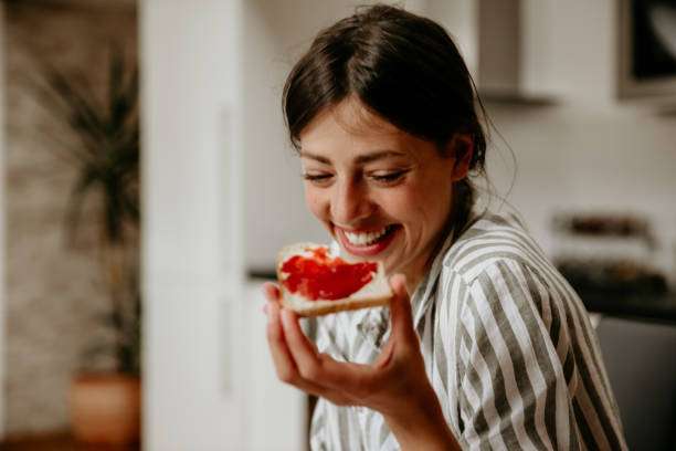 a beautiful young woman Holding jam toast, toaster