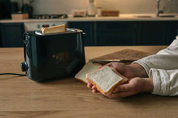 The toast is ready to be put into the toaster.