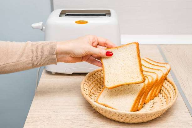 The toast is ready to be put into the toaster.