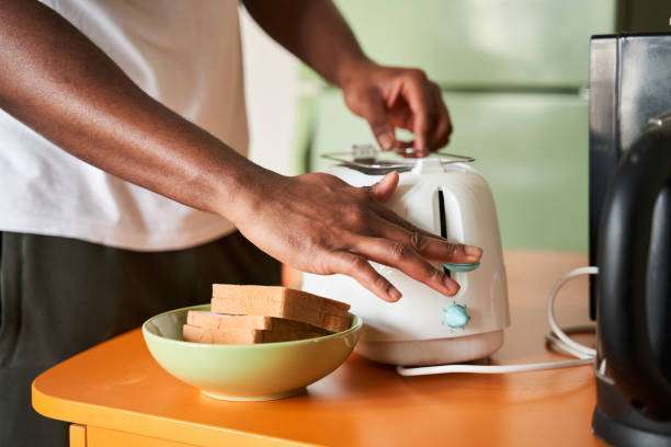 man turning the toaster