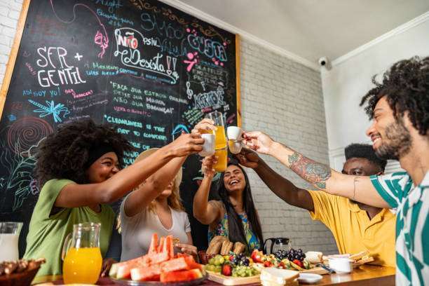 Friends toasting during breakfast at a hostel.Toaster