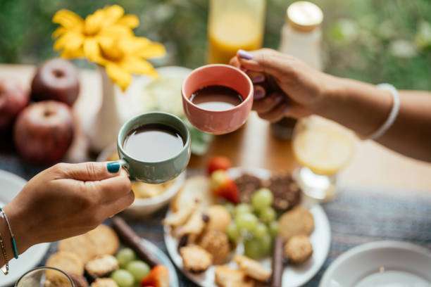 Close-up of a young couple toasting with cups of coffee.Toaster