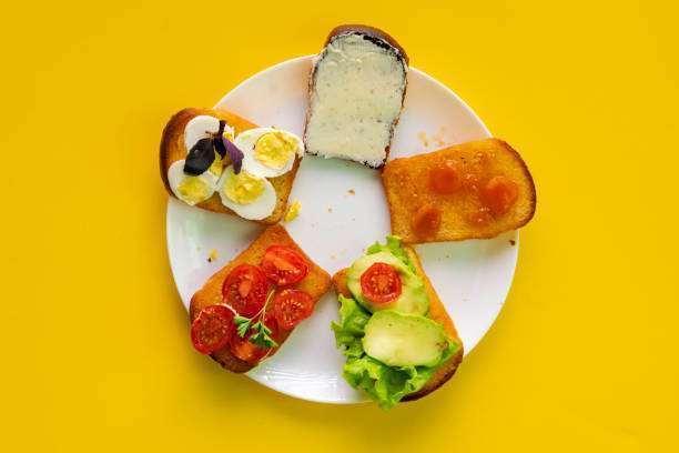 white ceramic plate with set of sandwiches with avocado, eggs, Toaster