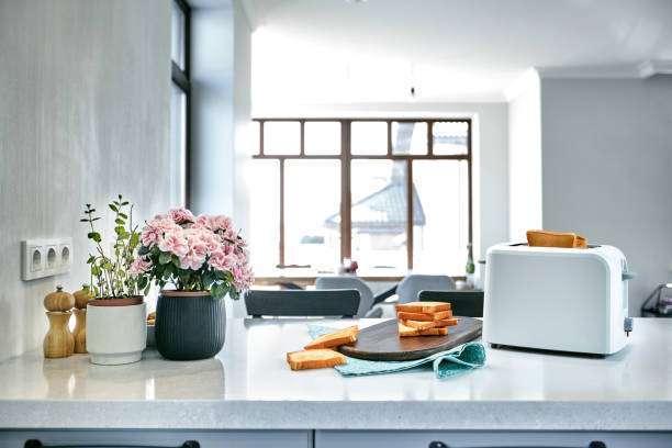 White toaster with toast on kitchen counter.