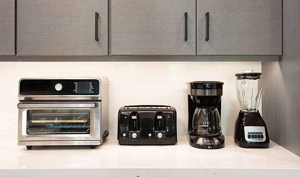 Kitchen counter displays a black toaster, convection oven, coffee maker, and blender.