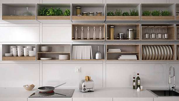 Minimalist white kitchen, open shelves, with a silver toaster on the clean countertop.