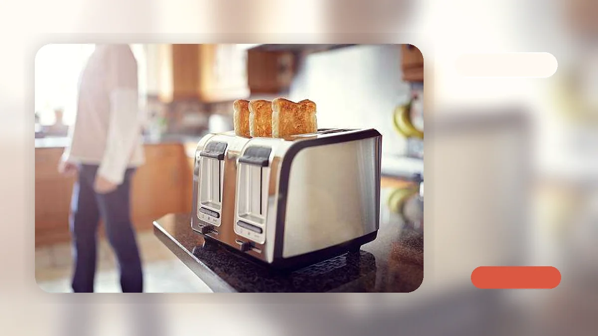A dense slice of rye bread being placed into a toaster with wide slots